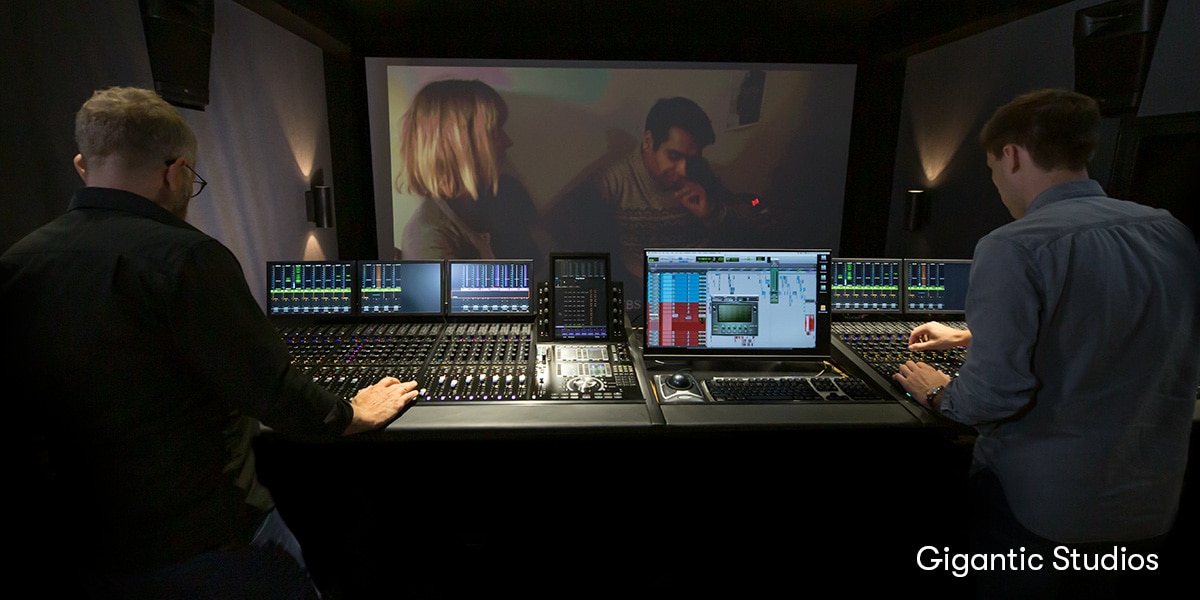 Image of two people at a Pro Tools and Dolby Atmos mixing workstation