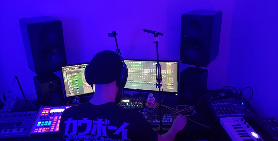 Laz Casanova mixing in a blue room