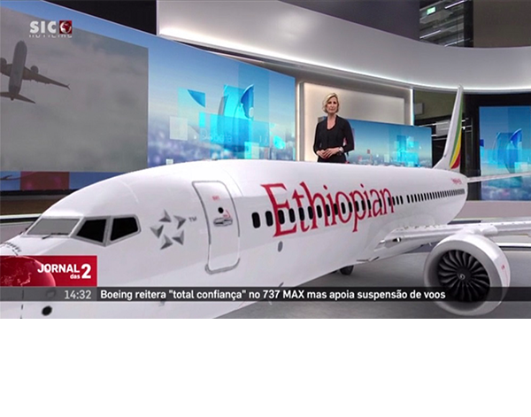 Female news anchor in studio behind a large AR graphic of a jet plane